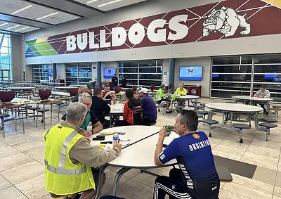 Yellow safety vest at a sports event at Bluebonnet Express facility.