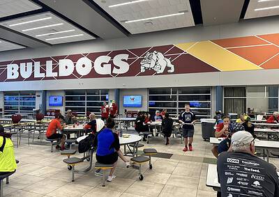 1. Bulldogs logo at Bluebonnet Express stadium with fans dining inside.