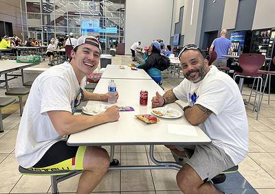 Bright young cyclist enjoying a meal at Bluebonnet Express in a modern, spacious indoor dining area.