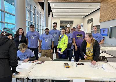 Volunteer group gathered indoors under natural lighting at Bluebonnet Express event.