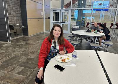 Comfortable woman enjoying meal at Bluebonnet Express, a popular stop for travelers.
