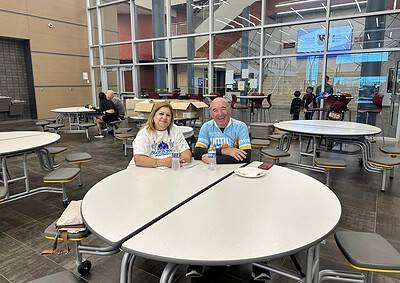 Bright indoor cafeteria at Bluebonnet Express with smiling passengers sitting at tables.