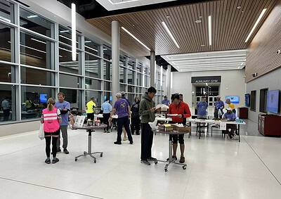 Bright indoor community event for bike enthusiasts at Bluebonnet Express, featuring registration and social interaction.