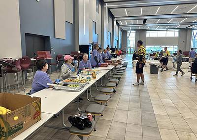 Bright, modern interior of Bluebonnet Express bus terminal with staff serving food and passengers dining.