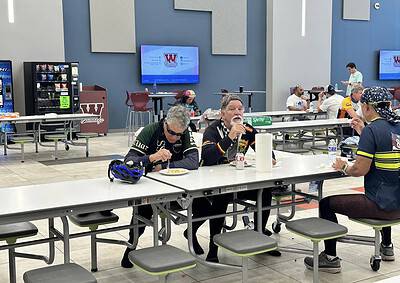 Friendly cyclists taking a break and enjoying a meal at Bluebonnet Express in a modern, inviting indoor space.