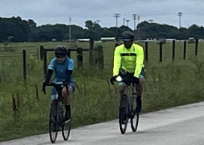 Bike riding along scenic countryside under overcast sky.