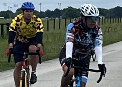 Cyclists riding on a scenic outdoor trail during daytime.
