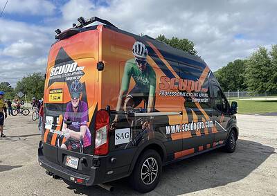 High-visibility cycling apparel van with team branding, promoting professional biking gear.