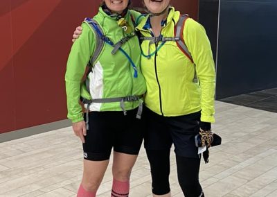 Women cyclists in bright cycling gear smiling after ride.