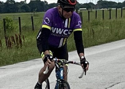 1. Male cyclist riding mountain bike on rural road during cloudy weather.