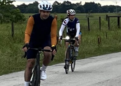 Vivid image of two cyclists riding on scenic countryside near Bluebonnet Express. Perfect for outdoor adventure and cycling enthusiasts.