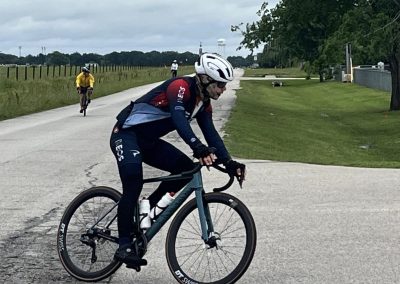 Rider on Bluebonnet Express cycling route during daytime in open countryside.