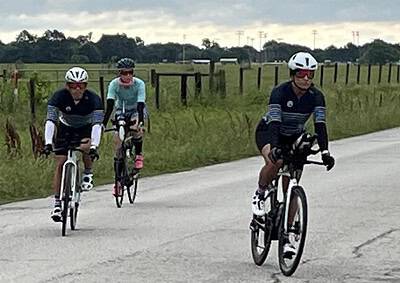 Riders enjoying a scenic bike ride on Bluebonnet Express trail with family and friends.