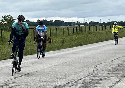 Cyclists riding on a rural bike trail in Texas during a cloudy day.
