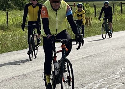 Bike riding in scenic countryside with group cyclists on the Bluebonnet Express route.