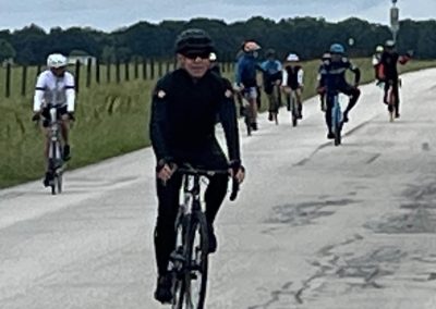Bicycle group ride on scenic country road, popular for cycling events and outdoor recreation.