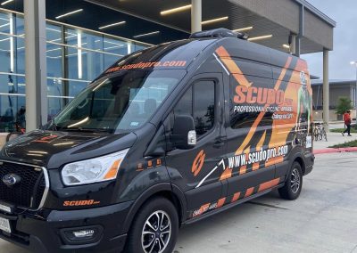 Promotional van for Bluebonnet Express bike delivery service, featuring professional cycling apparel branding.
