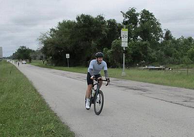 Bike ride along rural road with Bluebonnet Express signage, outdoor cycling event, community bike tour, Texas scenery, cycling safety.
