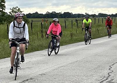 Cycling group enjoying scenic ride on Bluebonnet Express bike trail.