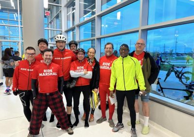 Popular cycling team group photo inside modern venue bluebonnet express event.