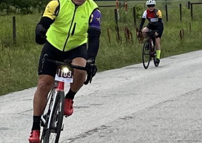High-visibility cyclist gear on two riders during Bluebonnet Express bike event in rural Texas.
