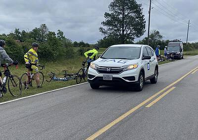 Bicyclist accident assistance with Honda vehicle on rural road in Texas during Bluebonnet Express event.