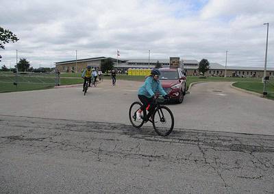 Cyclists riding near Bluebonnet Express in Texas, outdoor recreation, bike ride, community event, vibrant atmosphere.