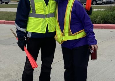 Brightly colored safety vests worn by volunteers for Bluebonnet Express parade.