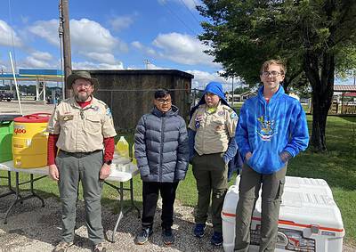 Scout leaders and members at Bluebonnet Express event, outdoors, sunny day, community activity.