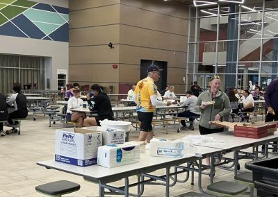 Bright indoor community space at Bluebonnet Express with people enjoying a meal and socializing.