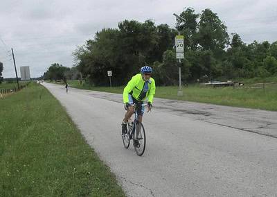 Bright neon yellow cycling jacket on a cyclist enjoying Bluebonnet Express bike trail.