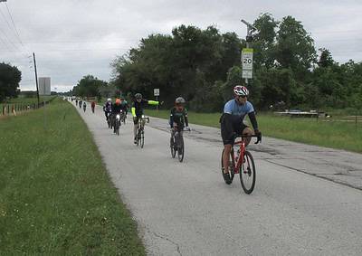 Cyclists riding on a rural road during Bluebonnet Express event in Texas for outdoor biking enthusiasts.