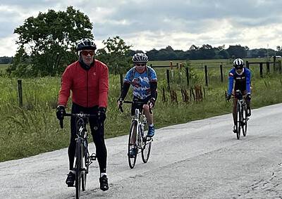 Active cyclists riding on a rural road, showcasing Bluebonnet Express cycling tour.