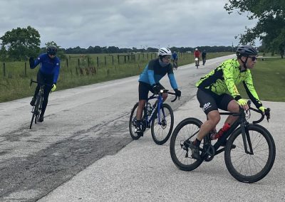 Vibrant group cycling outdoors on scenic Texas countryside, Bluebonnet Express scenic bike ride.