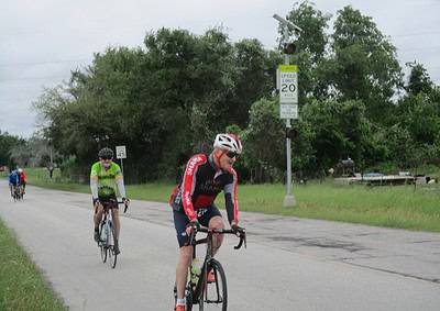 Cyclists riding on a rural road during a group bike ride.