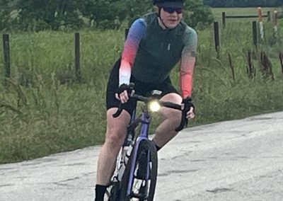 - Man riding a blue bicycle on scenic outdoor trail during daytime.