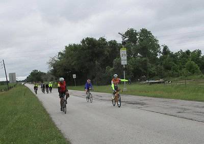 Cyclists riding on the Bluebonnet Express bike route in Texas, promoting eco-friendly transportation and outdoor recreation.