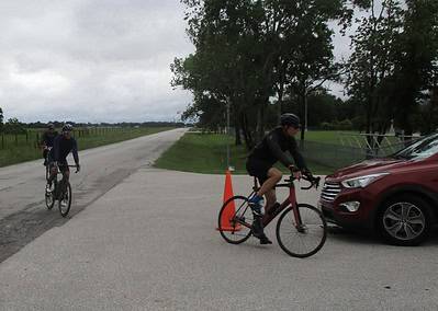 Cyclists riding along a rural road near Bluebonnet Express, scenic Texas bike trail.