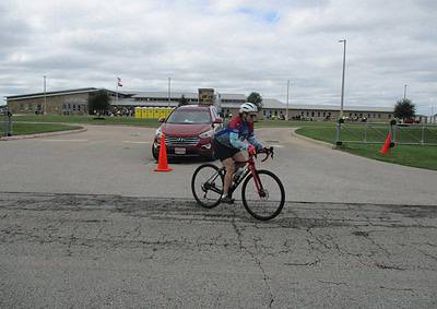 Cyclist riding near parking lot at Bluebonnet Express event.