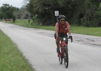 Bright cyclist on Bluebonnet Express bike trail, enjoying scenic outdoor riding experience.