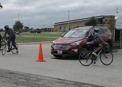 Bicycle riders on the street during a community cycling event.