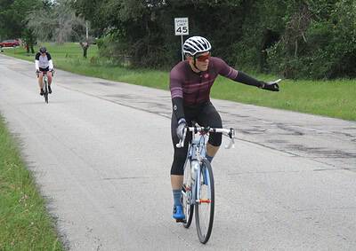 All-terrain cyclist riding on rural road with green landscape, promoting Bluebonnet Express bike service.
