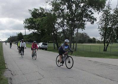 Bike riders on scenic outdoor trail in Texas, promoting Bluebonnet Express cycling event.
