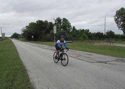 Scenic cyclist on rural road highlights Bluebonnet Express bike tours and adventure.