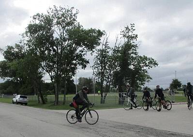 Bicycle group riding on a cloudy day at Bluebonnet Express trail, outdoor cycling event in Texas.