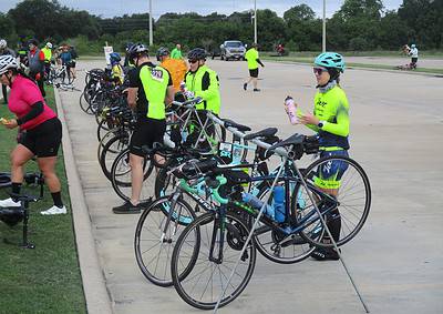 Bike race event, cyclists with high-visibility gear at Bluebonnet Express, Texas cycling race, outdoor sports.