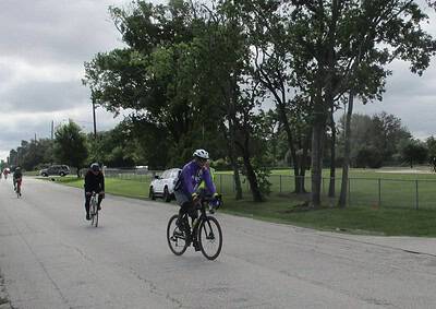 Bikers riding on a city street during a cycling event, promoting outdoor activity and community engagement.