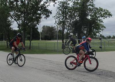 Riders on bicycles enjoying a ride on a cloudy day at Bluebonnet Express bike trail.