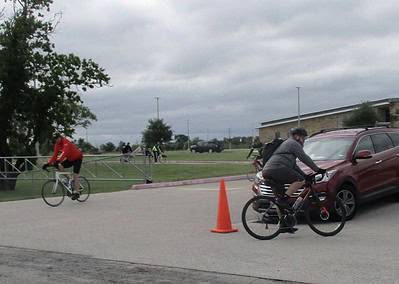 Cyclists participating in Bluebonnet Express bike event on a cloudy day.