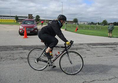 Cyclist riding a bike near traffic cones at Bluebonnet Express event.